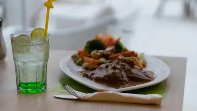 a plate of food on a table with a drink at Rivoli Suites in Hurghada