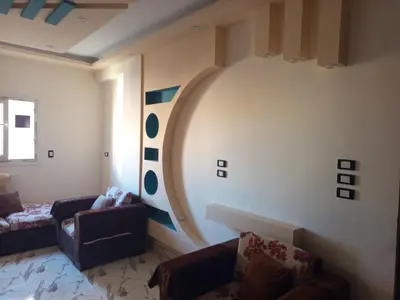 a living room with a large circle painted on the wall at hurghada , Elhegaz road in Hurghada