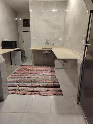a large bathroom with a sink and a rug at OBAI Nubian Guest House in Aswan