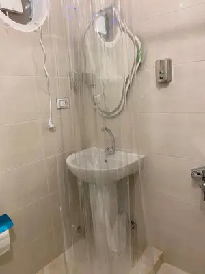 a bathroom with a shower with a sink in it at OBAI Nubian Guest House in Aswan