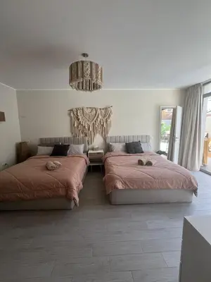 a bedroom with two beds and a chandelier at Bali - Elgouna Two Bedrooms private Heated pool in Hurghada
