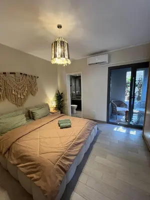 a bedroom with a large bed and a chandelier at Bali - Elgouna Two Bedrooms private Heated pool in Hurghada