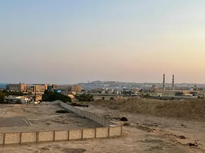 a view of a city with buildings and a fence at Beautiful desert, mountains, Hurghada skyline view in Hurghada