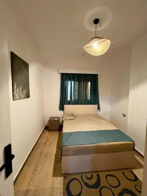 a small bedroom with a bed and a window at Beautiful desert, mountains, Hurghada skyline view in Hurghada