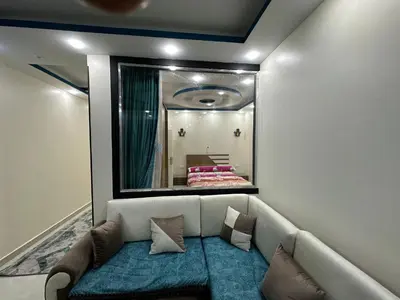a living room with a couch and a mirror at كورنيش القيادات in Hurghada