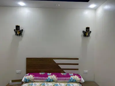 a bedroom with a bed and two lights on the wall at كورنيش القيادات in Hurghada