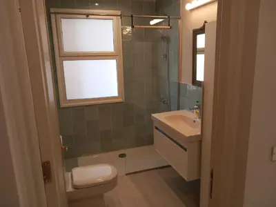 a bathroom with a toilet and a sink and a window at Modern Marina View 2 beds apt -New Marina-El Gouna in Hurghada
