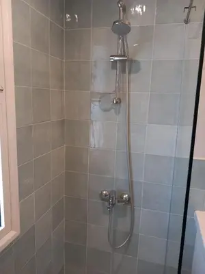 a shower with a shower head and a glass door at Modern Marina View 2 beds apt -New Marina-El Gouna in Hurghada