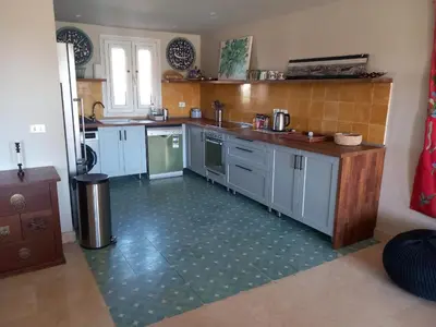 a kitchen with blue cabinets and a green tile floor at Modern Marina View 2 beds apt -New Marina-El Gouna in Hurghada