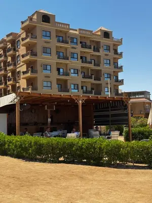 a large apartment building with a gazebo in front of it at Turtles Beach Resort Al-Ahyaa in Hurghada