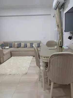 a living room with a couch and a table and chairs at Appartement for rent in Hurghada in Hurghada