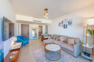 a living room with a couch and a table at 2-Bedroom Penthouse in G-Cribs Gouna in Hurghada