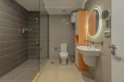 a bathroom with a toilet and a sink and a shower at 2-Bedroom Penthouse in G-Cribs Gouna in Hurghada