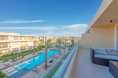 a view of the pool from the balcony of a resort at 2-Bedroom Penthouse in G-Cribs Gouna in Hurghada