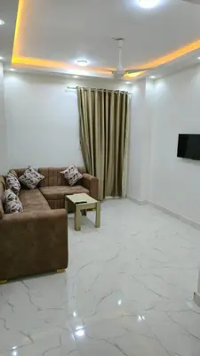 a living room with a couch and a table at البحر الاحمر الغردقه in Hurghada