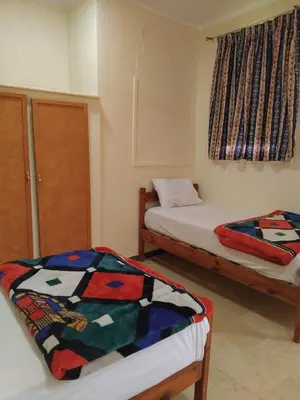 a room with two beds and a window at Ramsess Hotel in Luxor