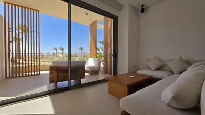 a living room with a couch and a table at Modern Minimalist Beach & Pool Side Somabay Cabana in Hurghada
