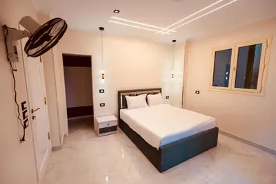a bedroom with a large bed in a room at signature house Luxor in Luxor