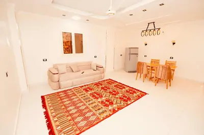 a living room with a couch and a table at signature house Luxor in Luxor