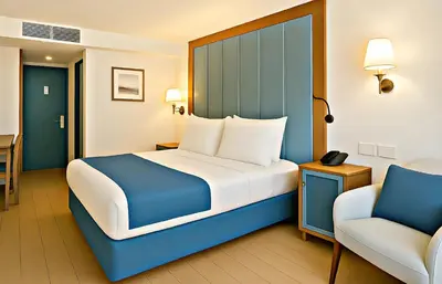 a bedroom with a blue and white bed and a chair at Five-Star Deluxe River Kruz from Aswan to Luxor 3 Nights in Aswān