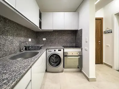 a kitchen with a washing machine and a sink at Poolside Townhome with 2 Masters, a Huge Terrace in El Gouna in Hurghada