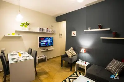 a living room with a couch and a table and a tv at Kite Lodging in Hurghada