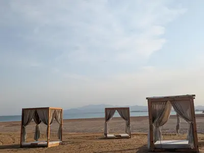 two beds on a beach with the ocean in the background at Beachy Pool side Mesca Cabana Somabay Steps to Sea in Hurghada