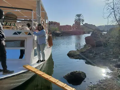 a woman standing on the side of a boat at Nubiana Boat