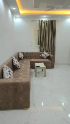 a living room with two couches and a coffee table at عمارة الرومانى in Hurghada