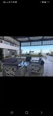 a screened in porch with couches and a table at الغردقه قريه فنادير باى in Hurghada