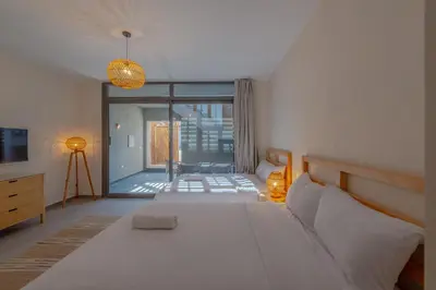 a bedroom with a large white bed and a balcony at Dreamy Studio in Bali Compound, El Gouna in Hurghada