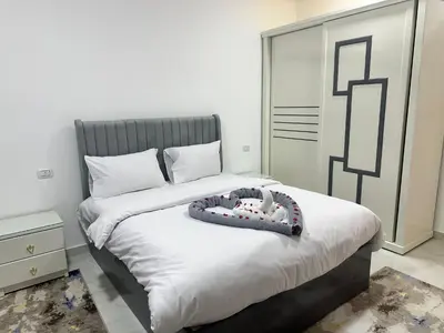 a bedroom with a bed with a stuffed animal on it at Hamed's House Luxor in Luxor