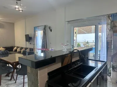 a kitchen with a sink and a living room at Hamed's House Luxor in Luxor