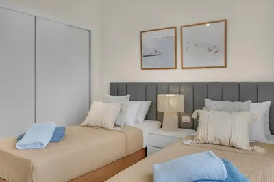 a living room with two beds and a couch at Bright & Elegant 2BR Retreat - Kamaran El Gouna in Hurghada