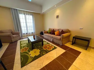 a living room with a couch and a table at Tawaya Sahl Hasheesh 2 bedrooms in Hurghada