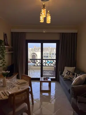 a living room with a couch and a table at Gravity Apartment 410 beautiful apartment with view in structure Gravity Sahl Hasheesh -No Egyptian Passports in Hurghada
