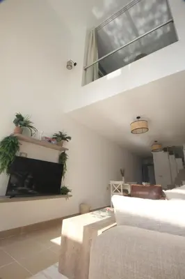 a living room with a couch and a fireplace at Modern Sahl Hasheesh Pool Duplex - Beach & Wi-Fi in Hurghada