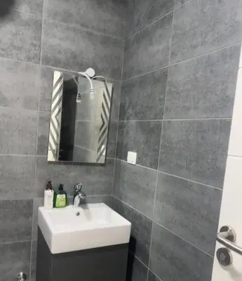 a bathroom with a sink and a mirror at 412atthepavilionimperialHurghada in Hurghada