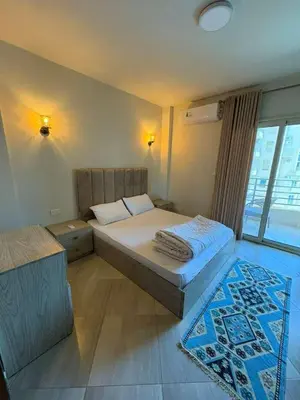 a bedroom with a large bed and a window at Amazing View! Beach Access & Pool Hurghada in Hurghada