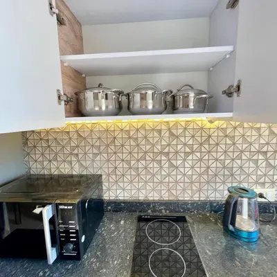 a kitchen with two pots on top of a microwave at Tiba Golden Resort Hurghada in Hurghada