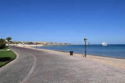 a road next to a beach with the water at 310 el Andalous Apartment in Hurghada