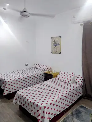 two beds in a room with red and white polka dots at Economy Onebedroom Apartment Hurghada in Hurghada