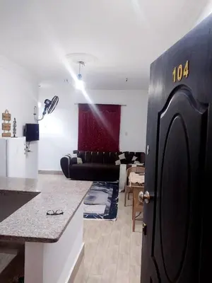 a kitchen and living room with a black refrigerator at Economy Onebedroom Apartment Hurghada in Hurghada