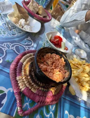 a table topped with plates of food and bowls of food at Nubian Dreams guest house 2 in Aswan