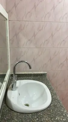 a white sink in a bathroom with a counter at الغردقة - القيادات - بالقرب من سيتي سنتر مول و شاطئ الجيش in Hurghada