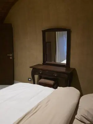a bedroom with a bed and a dresser with a mirror at Lovely Private Villa in Luxor