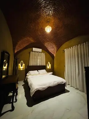 a bedroom with a large bed and a piano at Lovely Private Villa in Luxor