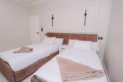 two beds in a room with white walls at ElMena House Luxor in Luxor