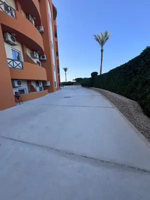 an empty sidewalk in front of a building at شاليه اوزيس Oasis Chalet in New cairo
