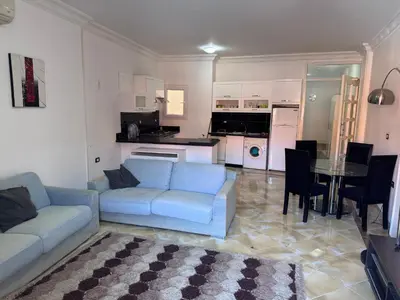 a living room with a couch and a table at شاليه اوزيس Oasis Chalet in New cairo